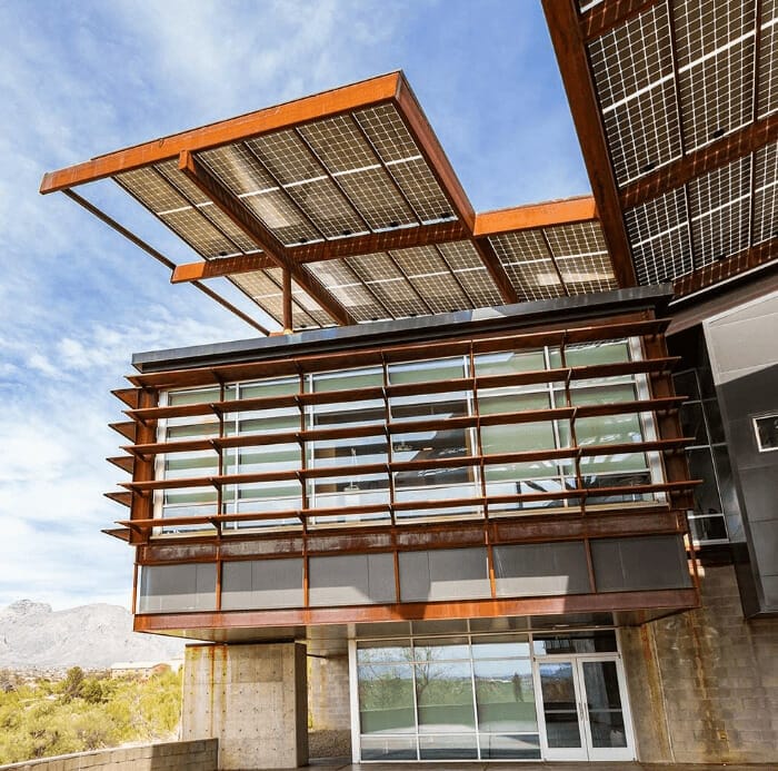 Exterior of Sleep Perfection Center with large solar panel overhangs and a glass facade featuring horizontal sunshades