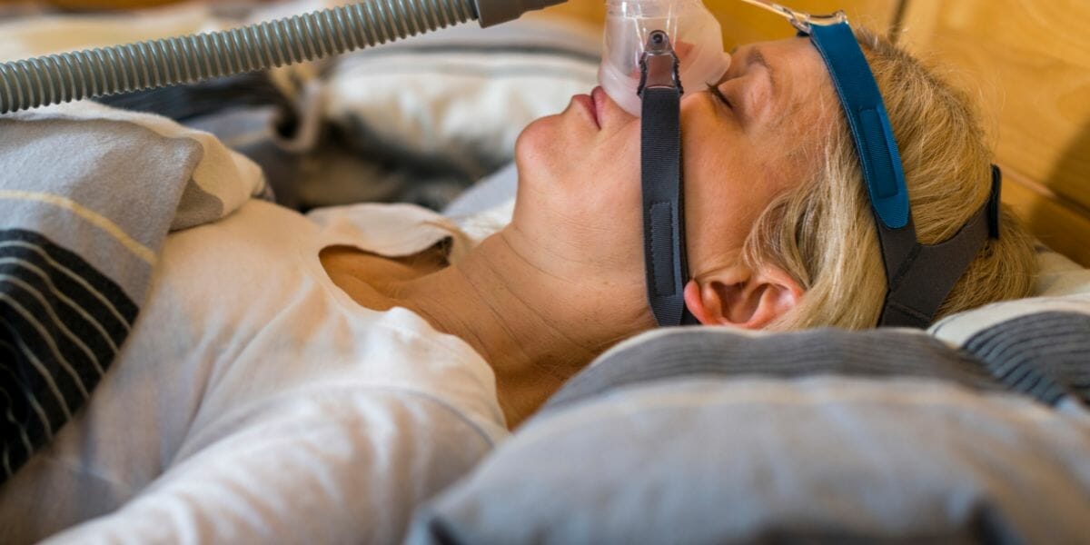 woman sleeping with sleep apnea machine