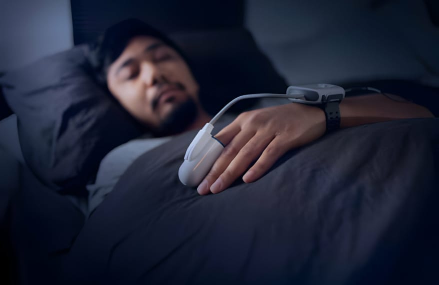 person sleeping with finger monitor