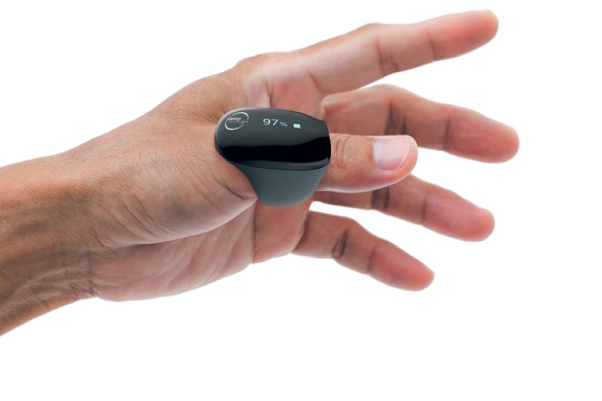 A close-up of a hand wearing a digital pulse oximeter that displays a 97% oxygen saturation level