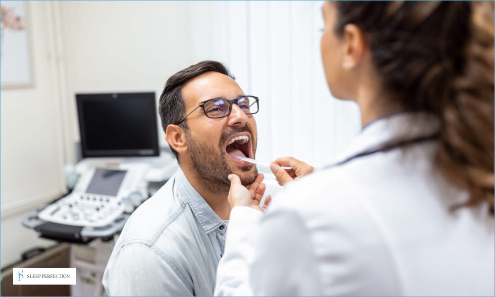 A doctor examining a male patient’s throat during a medical checkup