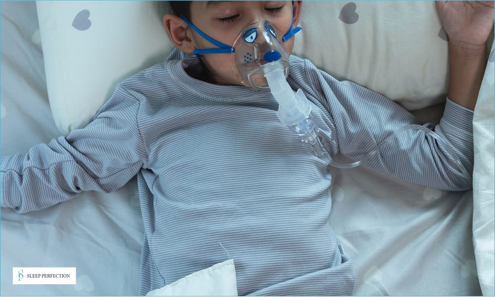 A child sleeps in bed wearing a mask for assisted breathing