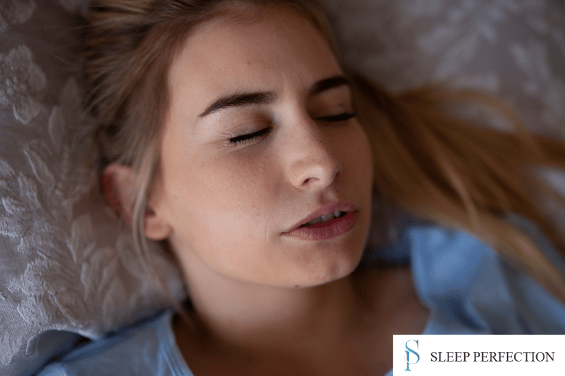 Woman grinding teeth while asleep showing sleep bruxism symptoms